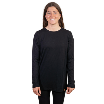 Front shot of Ottie Merino women's black long sleeve merino wool t-shirt on 166cm model who is wearing a size small
