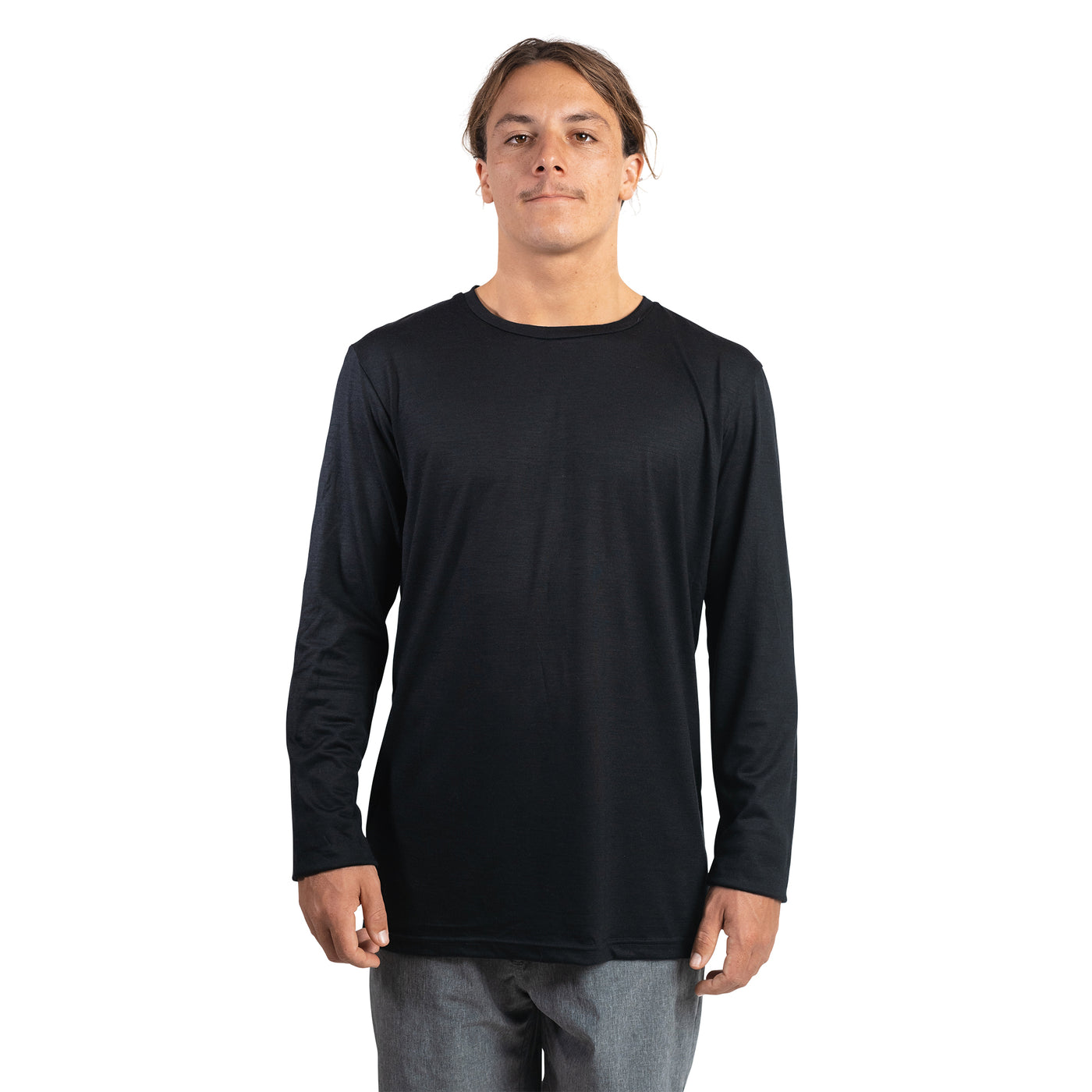 Front shot of Ottie Merino men's black long sleeve merino wool t-shirt on 173cm model who is wearing a size medium