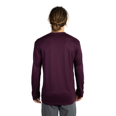 Back shot of Ottie Merino men's Plum long sleeve merino wool t-shirt on 173cm model who is wearing a size medium