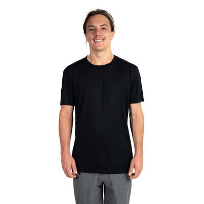 Front shot of Ottie Merino men's black short sleeve merino wool t-shirt on 173cm model who is wearing a size medium
