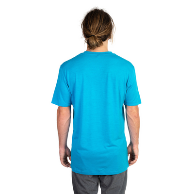 Back shot of Ottie Merino men's Coastal Blue short sleeve merino wool t-shirt on 173cm model who is wearing a size medium