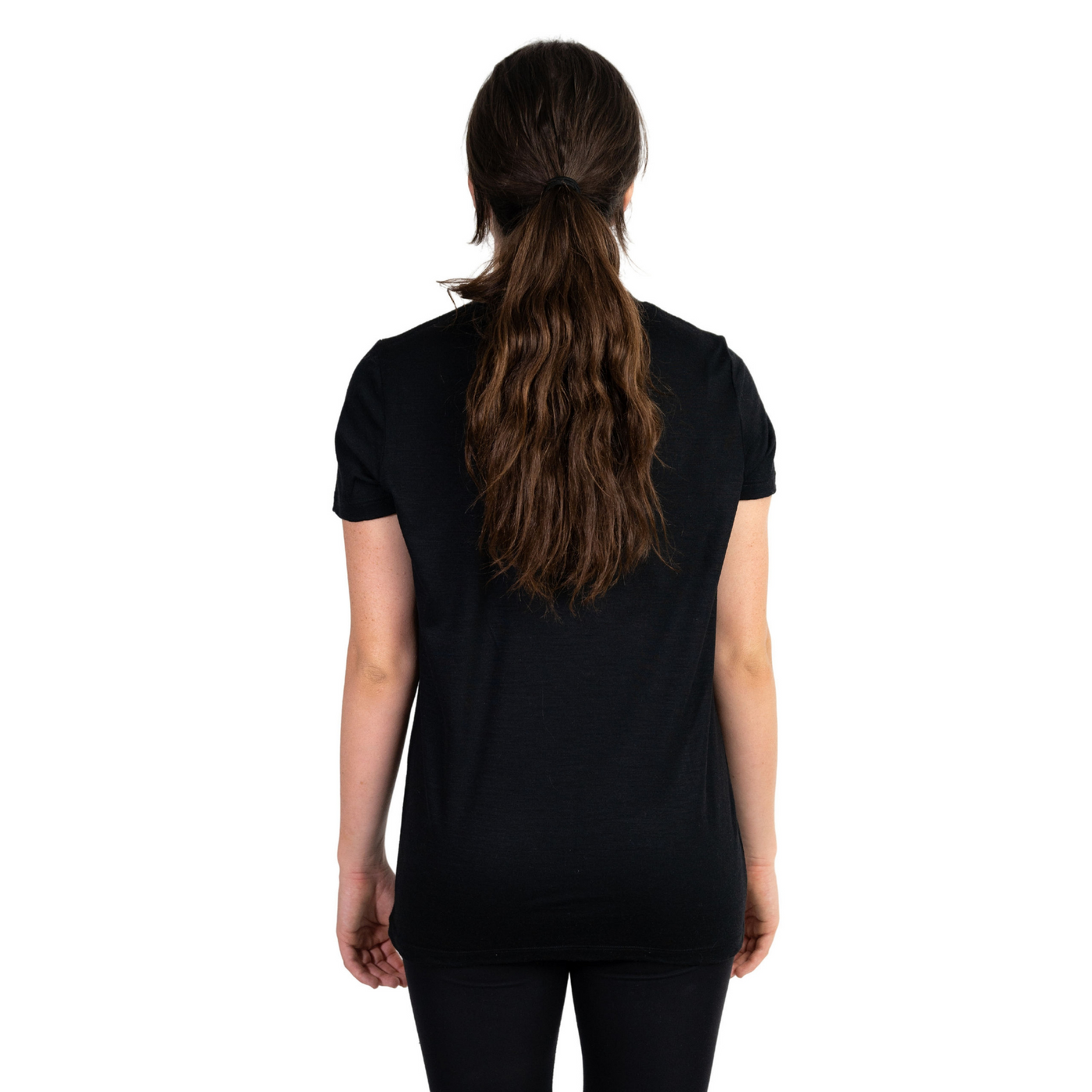 Back shot of Ottie Merino women's black short sleeve merino wool t-shirt on 166cm model who is wearing a size small