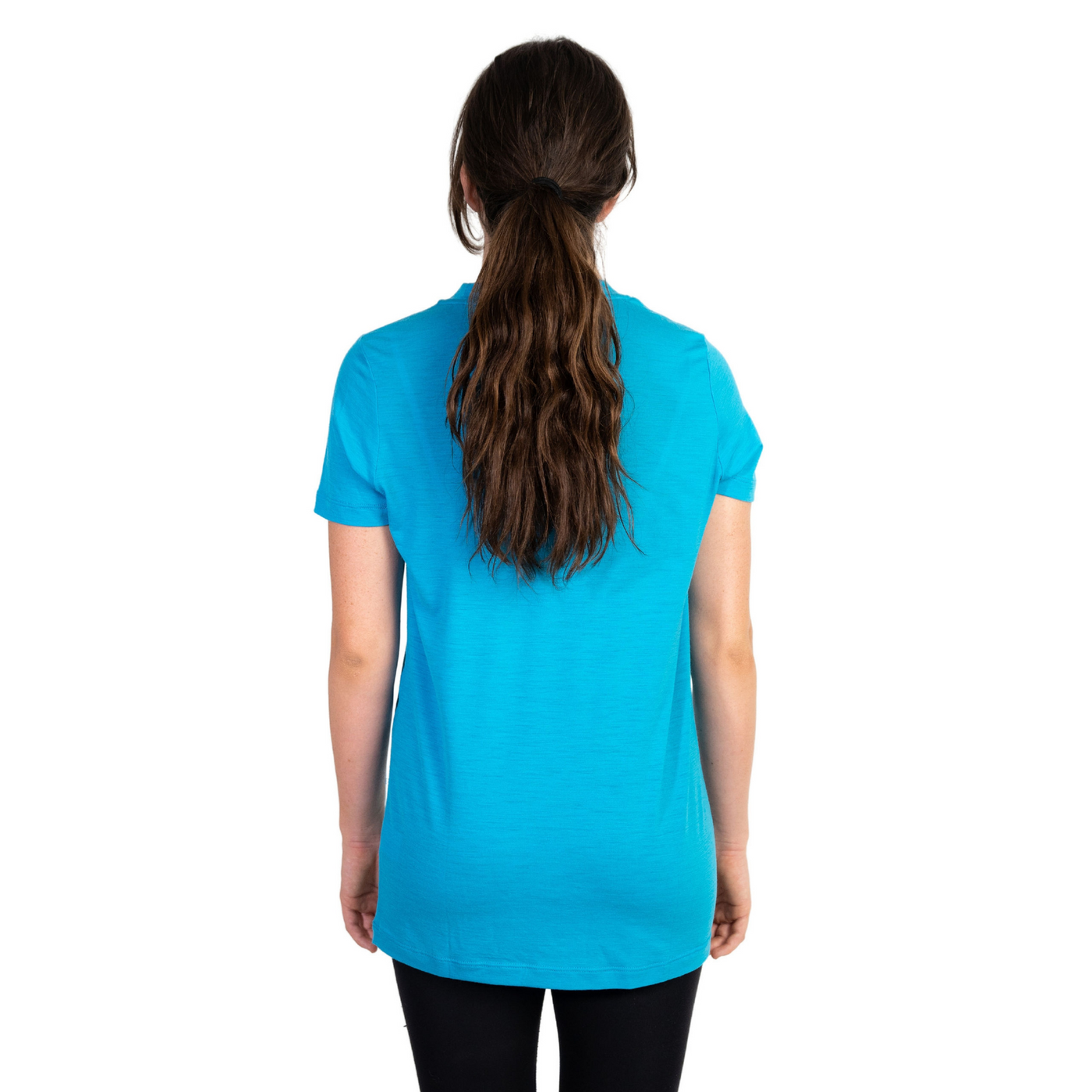Back shot of Ottie Merino women's Coastal Blue short sleeve merino wool t-shirt on 166cm model who is wearing a size small